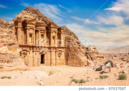 Ad Deir or The Monastery, ancient Nabataean stone carved temple, with donkeys in the foreground Ad Deir or The Monastery, ancient Nabataean stone carved temple, with donkeys in the foreground 97037087