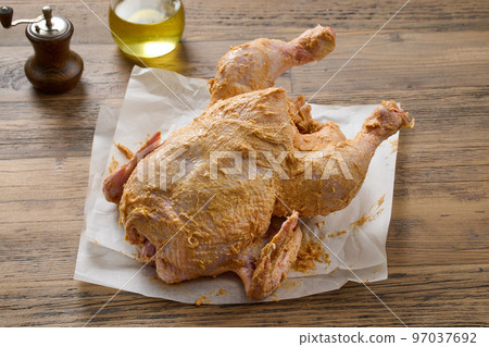 raw chicken covered with spicy butter 97037692