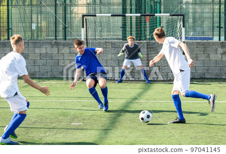 Young football players fighting for ball Young football players fighting for ball 97041145