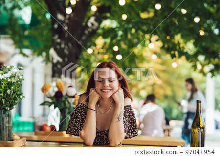 Close-up portrait of two female at summer street cafe 97041954