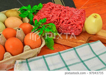 Mince. Ground meat with ingredients for cooking. Mixed minced meat ready to making burgers, fatty's, meaetballs. Food photography. Culinary concept. Minced meat recipe Mince. Ground meat with ingredients for cooking. Mixed minced meat ready to making burgers, fatty's, meaetballs. Food photography. Culinary concept. Minced meat recipe 97043735