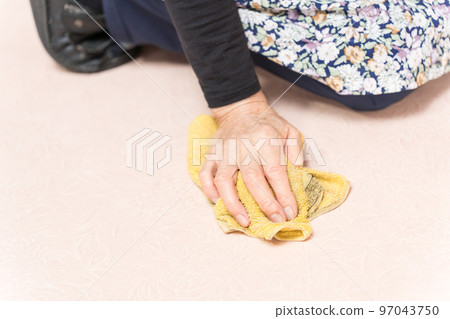 Senior woman mopping the floor Senior woman mopping the floor 97043750