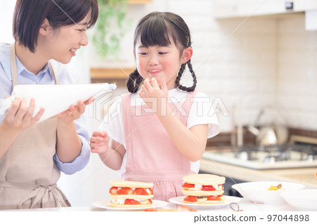 Family A girl and a mom who make pancakes Family A girl and a mom who make pancakes 97044898
