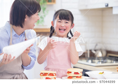 Family A girl and a mom who make pancakes Family A girl and a mom who make pancakes 97044899
