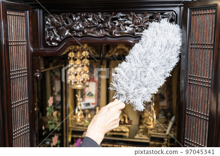 Cleaning the Buddhist altar Dust off with a duster Cleaning the Buddhist altar Dust off with a duster 97045341