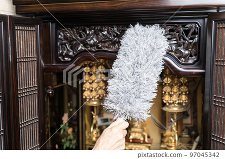 Cleaning the Buddhist altar Dust off with a duster 97045342