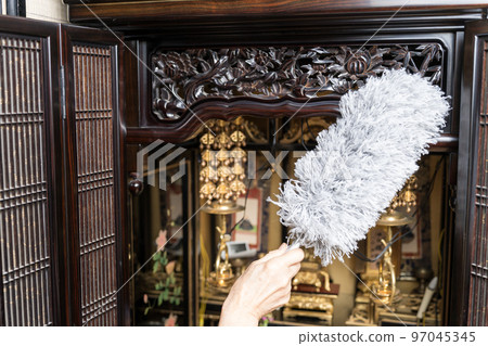 Cleaning the Buddhist altar Dust off with a duster Cleaning the Buddhist altar Dust off with a duster 97045345