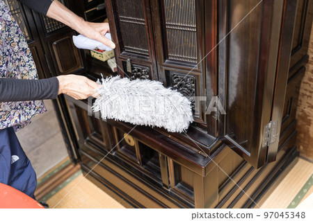 Cleaning the Buddhist altar Dust off with a duster 97045348