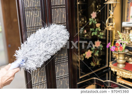 Cleaning the Buddhist altar Dust off with a duster Cleaning the Buddhist altar Dust off with a duster 97045360