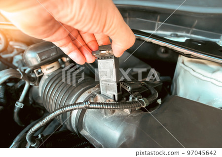 The mass air flow sensor is installed in the engine air intake manifold system by a auto mechanic 97045642