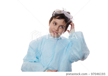 Isolated portrait on white background of a handsome schoolkid, adorable Caucasian teenage boy, a young chemist scientist wearing lab coat and safety goggles, looking aside at copy advertising space 97046193