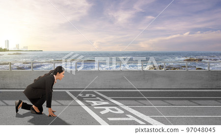Asian businesswoman in start position ready to run Asian businesswoman in start position ready to run 97048045