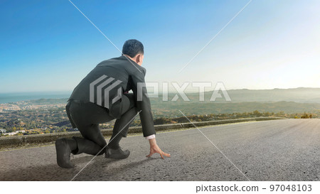 Rear view of Asian businessman in start position ready to run Rear view of Asian businessman in start position ready to run 97048103