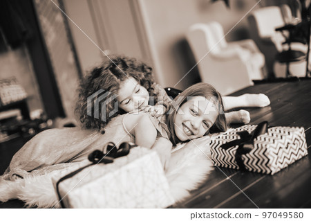 two pretty sisters lying on the floor in a cozy living room. black and white photo two pretty sisters lying on the floor in a cozy living room. black and white photo 97049580