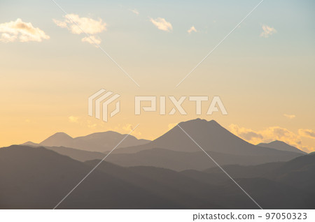 Pale gradation sky and mountain ridge silhouette. Mount Oakan in Hokkaido. Pale gradation sky and mountain ridge silhouette. Mount Oakan in Hokkaido. 97050323
