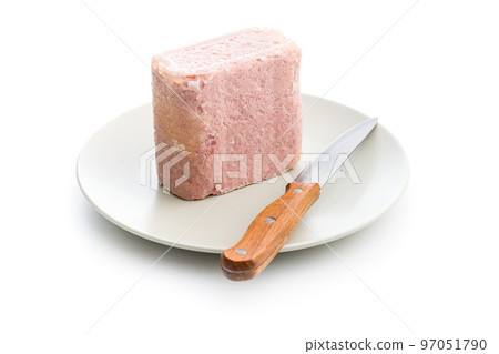 Luncheon meat on plate isolated on white background. 97051790