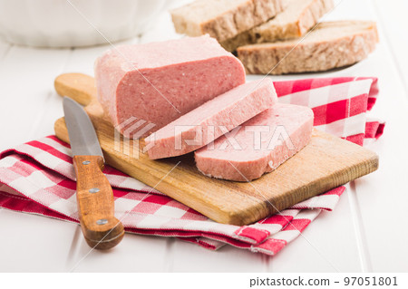 Luncheon meat on cutting board. 97051801