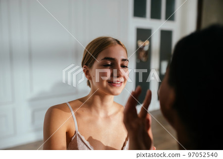 Close-up of two women applying cream to each other's faces Close-up of two women applying cream to each other's faces 97052540