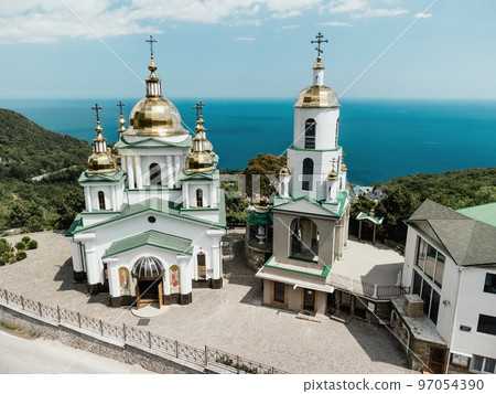 Christian church in the mountains above the sea. Temple of the Holy Archangel Michael in Oreanda. The southern coast of Crimea. Aerial view Christian church in the mountains above the sea. Temple of the Holy Archangel Michael in Oreanda. The southern coast of Crimea. Aerial view 97054390