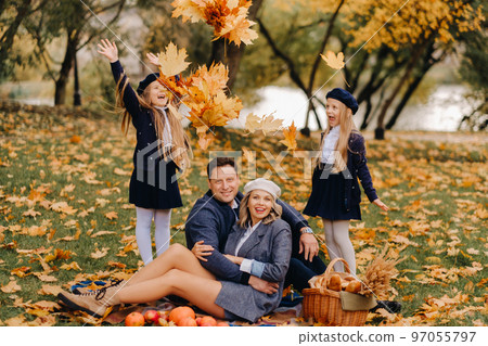 A big family on a picnic in the fall in a nature park. Happy people in the autumn park 97055797
