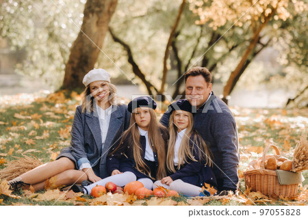 A big family on a picnic in the fall in a nature park. Happy people in the autumn park 97055828