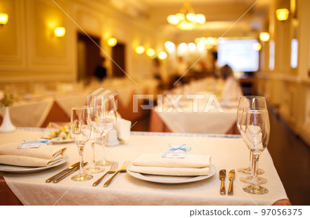 Beautiful table setting with crockery and flowers for a party, wedding reception or other event. 97056375