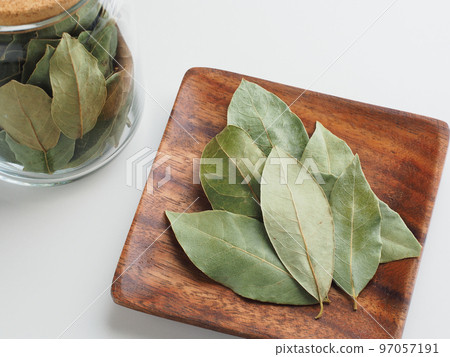Dried bay leaves on a wooden plate Dried bay leaves on a wooden plate 97057191