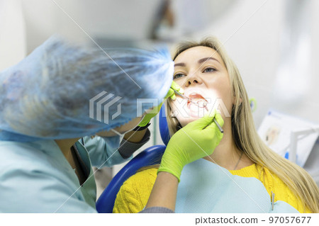 Dental health concept. female mouth on treatment in a dental clinic, 97057677