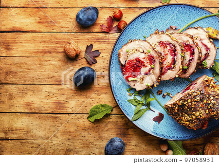 Juicy meatloaf with plums,space for text 97058931