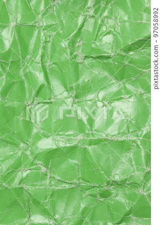 Textured crumpled green cardboard paper background. Textured crumpled green cardboard paper background. 97058992