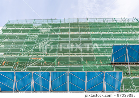 High-rise building construction site with measures against falling objects High-rise building construction site with measures against falling objects 97059883