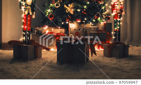 Three Christmas gift box on the white carpet with glowing lights Three Christmas gift box on the white carpet with glowing lights 97059947
