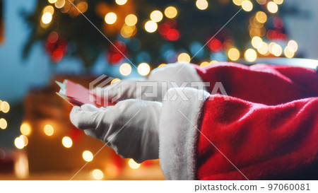Santa Claus opening the letter for Christmas asks of children Santa Claus opening the letter for Christmas asks of children 97060081