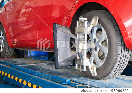 Car wheel alignment in progress at auto repair service centre 97060255
