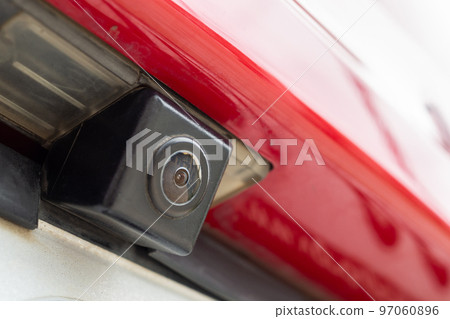 Red car rear view camera close up for parking assistance Red car rear view camera close up for parking assistance 97060896