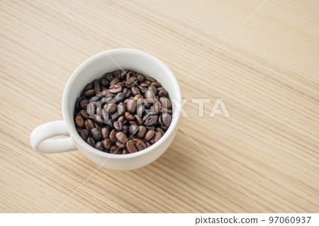 fresh roasted coffee beans in white cup on wood table fresh roasted coffee beans in white cup on wood table 97060937