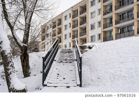 Stairs leads to top of hill covered in snow Stairs leads to top of hill covered in snow 97061016