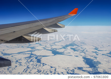 The wing of the aircraft over the Arctic ocean 97061800