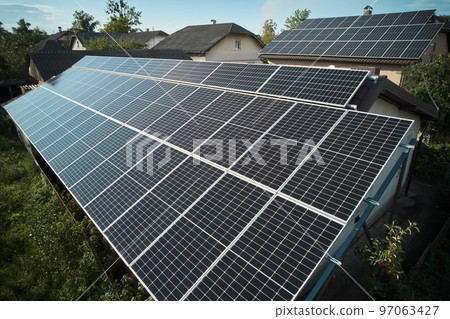 Aerial top view of new modern house cottage with solar photovoltaic panel system on house roof 97063427