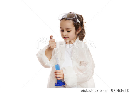 Smart little girl, student chemist-scientist in lab coat, dripping few drops of reagent from graduated pipette into a measuring cylinder with chemical solution, at a chemistry lesson. White background Smart little girl, student chemist-scientist in lab coat, dripping few drops of reagent from graduated pipette into a measuring cylinder with chemical solution, at a chemistry lesson. White background 97063618
