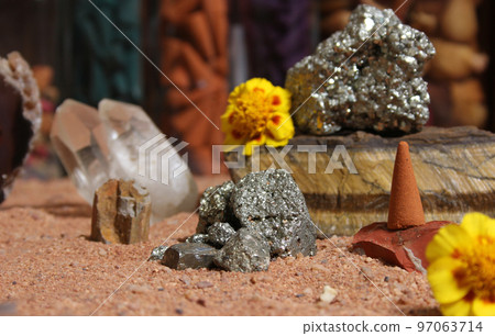 Yellow Flower With Pyrite Rocks and Crystals on Australian Red Sand Yellow Flower With Pyrite Rocks and Crystals on Australian Red Sand 97063714