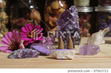 Amethyst Crystals With Flowers and Incense Cones on Meditation Table 97063721
