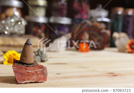 Incense Cones and Chakra Stones With Flowers in Background Shallow DOF Incense Cones and Chakra Stones With Flowers in Background Shallow DOF 97063723