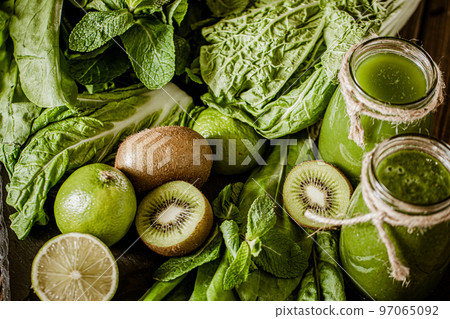 Closeup of fresh green smoothie in glass jars with lime. Detox concept. Good food 97065092