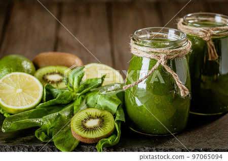 Closeup of fresh green smoothie in glass jars with lime. Detox concept. Good food 97065094