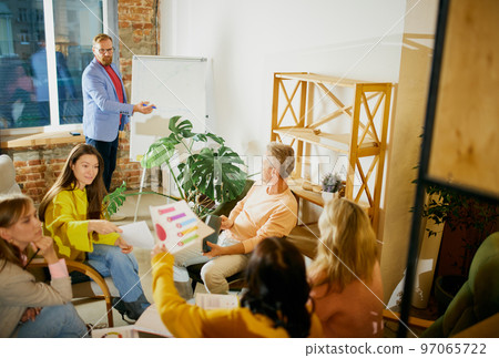 Colleagues, coworkers, men and women on business meeting working on new project, making strategy at the office, indoors. Concept of business, brainstorming, conference 97065722