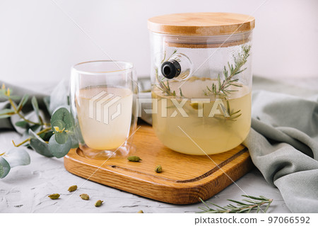 Summer cold tea and fresh herbs rosemary in glasses Summer cold tea and fresh herbs rosemary in glasses 97066592