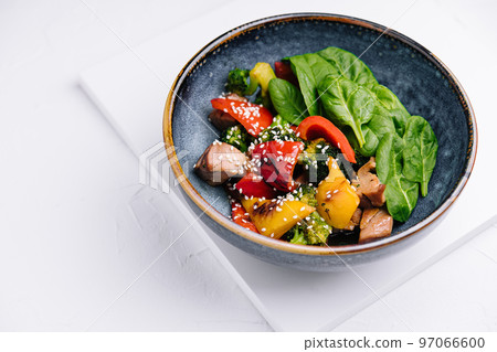 meat with grilled vegetables in bowl 97066600