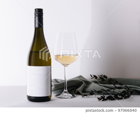 Bottle and glass of white wine isolated on white background 97066840