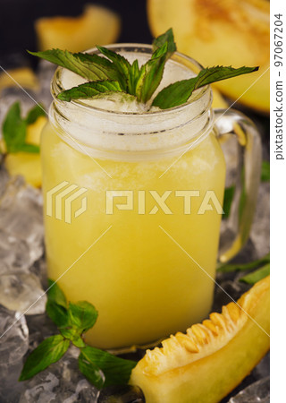 glass of melon smoothie with mint leaves glass of melon smoothie with mint leaves 97067204
